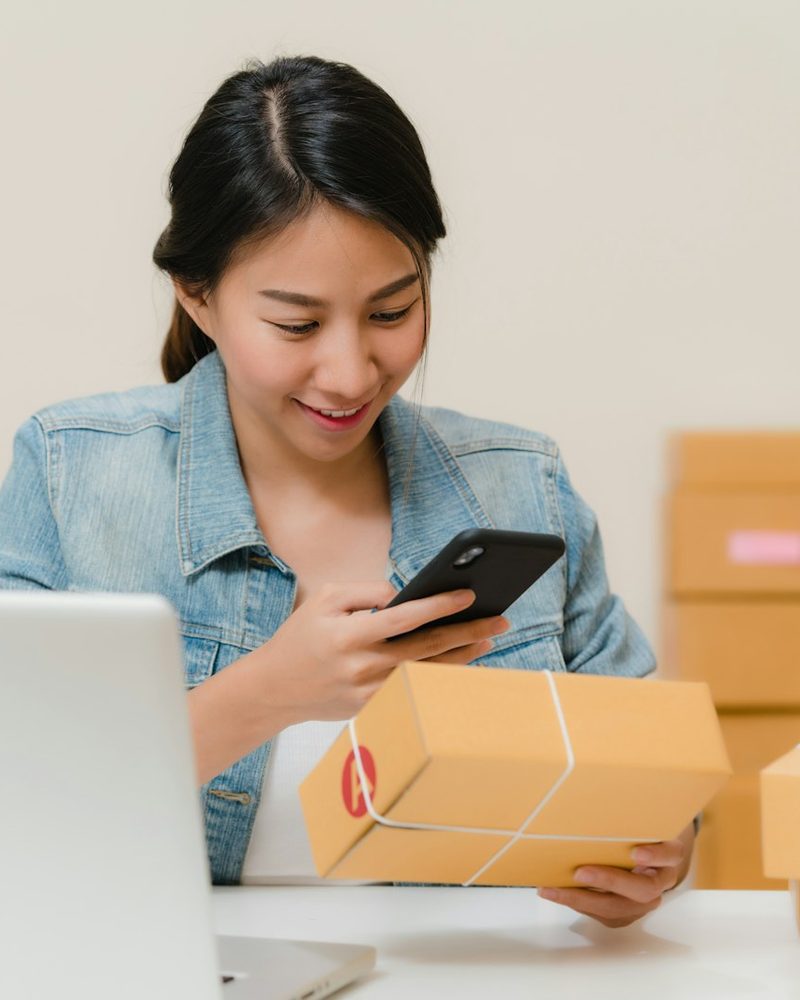 Online seller confirming an order on her phone