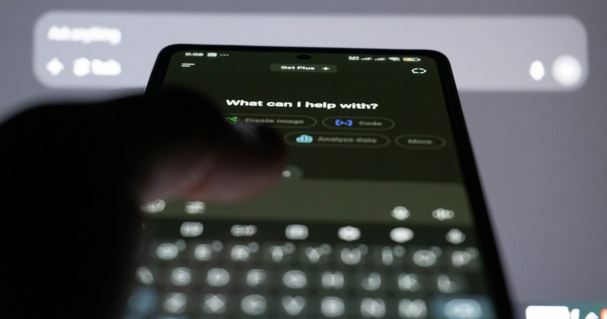 Orang mengetik pesan di smartphone yang menampilkan antarmuka chatbot AI